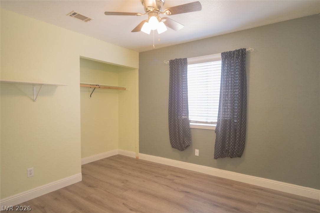 121 Heather Drive, Henderson, NV 89002 Plank flooring and a closet alcove define this versatile bedroom space.