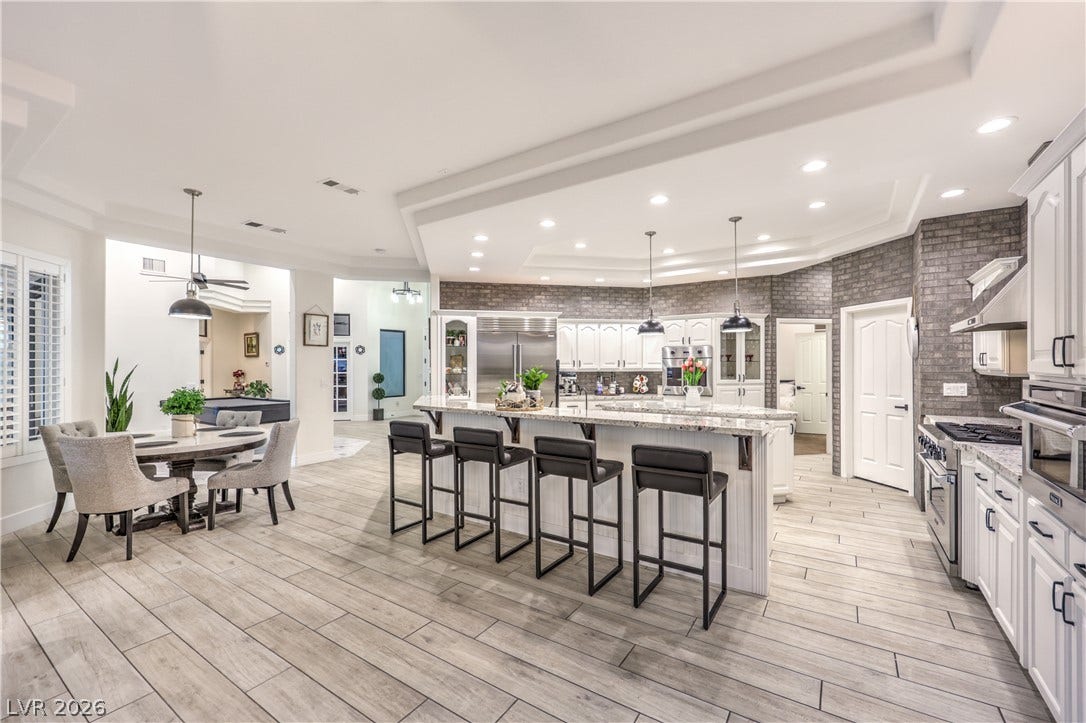 An open floorplan seamlessly connects the culinary space to a casual dining area.
