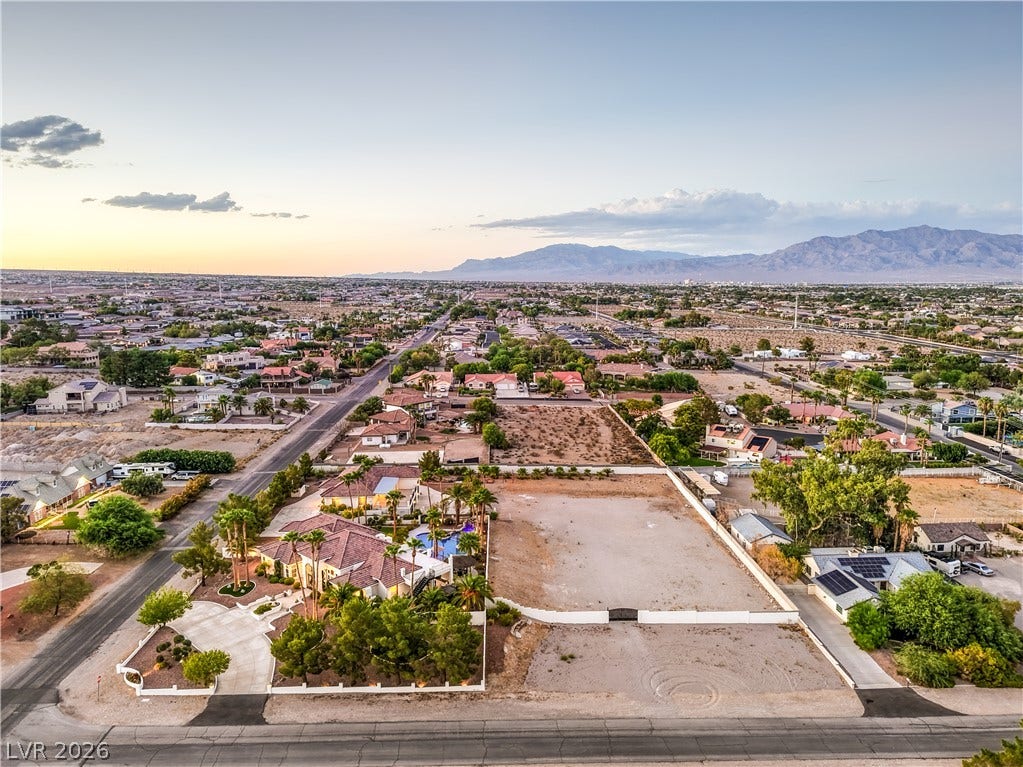 Panoramic mountain and desert vistas surround this expansive neighborhood under vast skies.