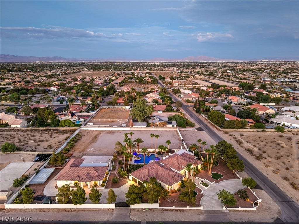 Panoramic neighborhood views extend toward distant mountains from this expansive desert estate.