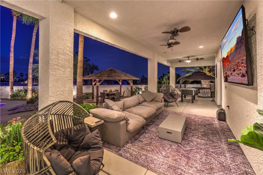 A spacious covered patio seamlessly connects to the outdoor living area under a starry sky.