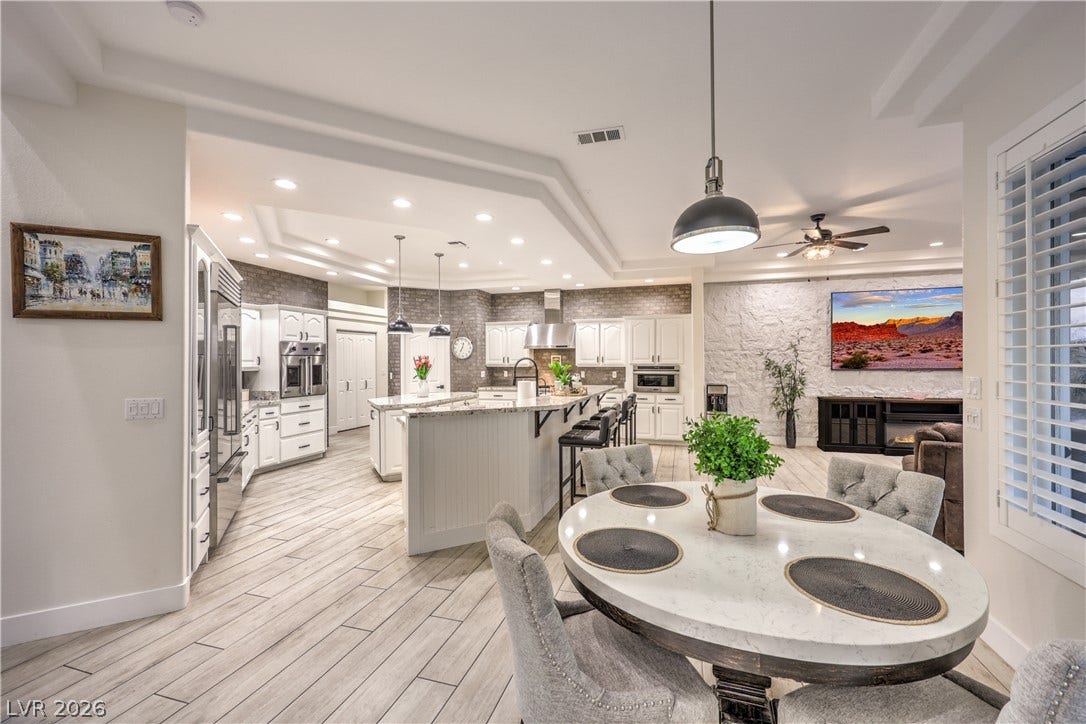Gleaming tiled floors sweep through this modern layout, linking dining and culinary spaces.