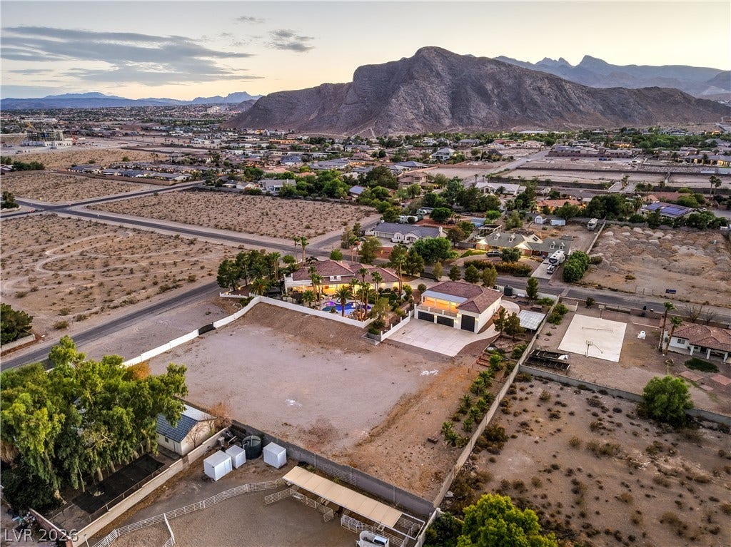 9390 Stange Avenue, Las Vegas, NV 89129 Dramatic mountain peaks frame an expansive desert property with a sprawling residential estate.