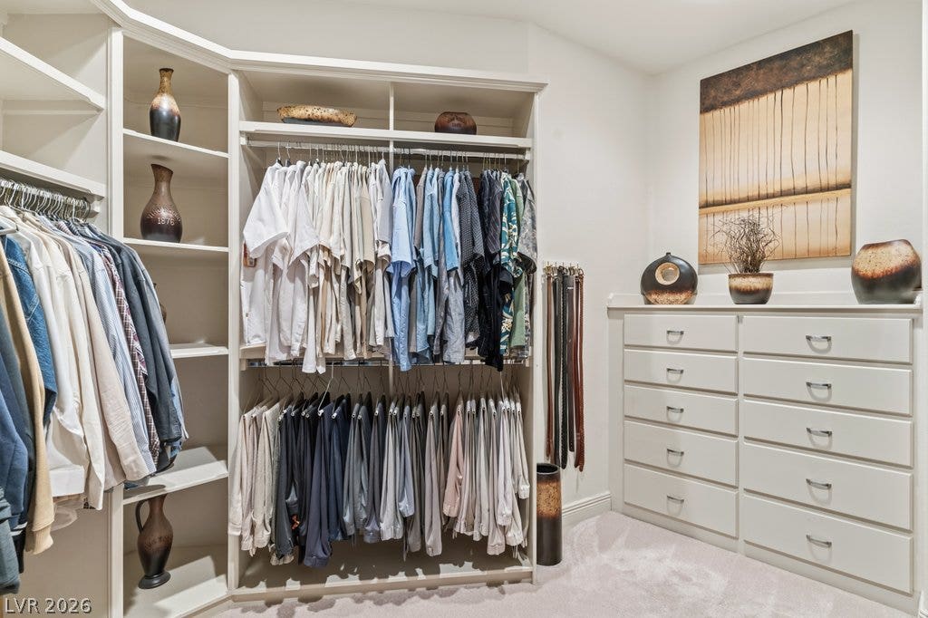 1632 Marbella Ridge Court, Las Vegas, NV 89117 Custom built-in shelving, drawers, and carpeted flooring maximize organization in this spacious dressing area.