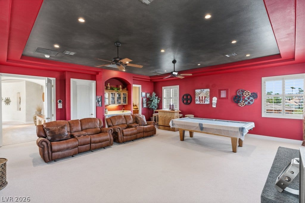 1632 Marbella Ridge Court, Las Vegas, NV 89117 A spacious game room features a tray ceiling, recessed lighting, and soft carpet flooring.
