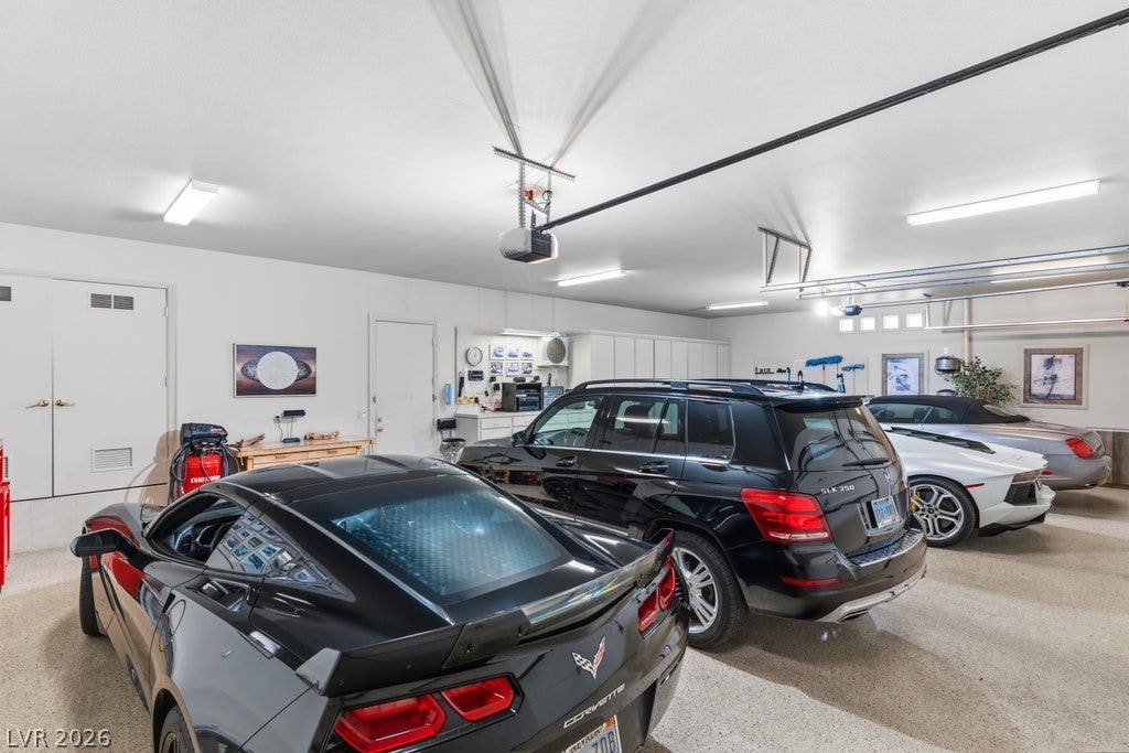 1632 Marbella Ridge Court, Las Vegas, NV 89117 An immaculate multi-car garage features durable finished flooring and integrated ceiling tracks.