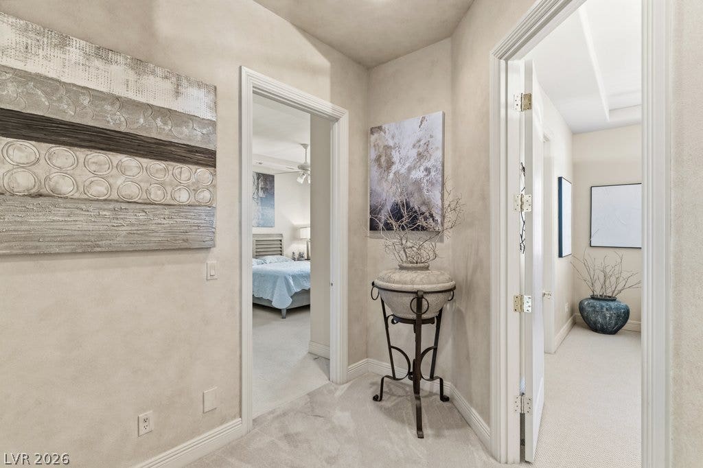 1632 Marbella Ridge Court, Las Vegas, NV 89117 Smooth textured walls and plush carpeting flow through the bright hallways of this home.