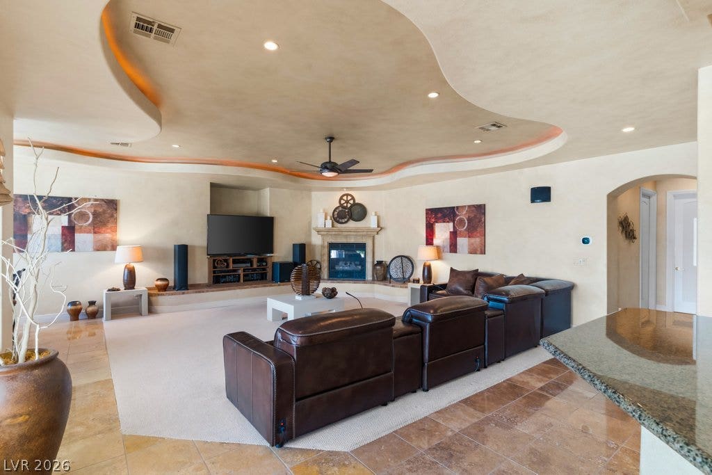 1632 Marbella Ridge Court, Las Vegas, NV 89117 Inlaid tile borders and a custom curvilinear ceiling details define this open living space.
