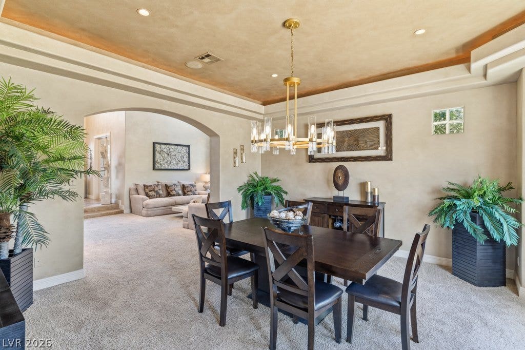 1632 Marbella Ridge Court, Las Vegas, NV 89117 An arched transition leads from this formal dining space with textured ceilings into the living area.