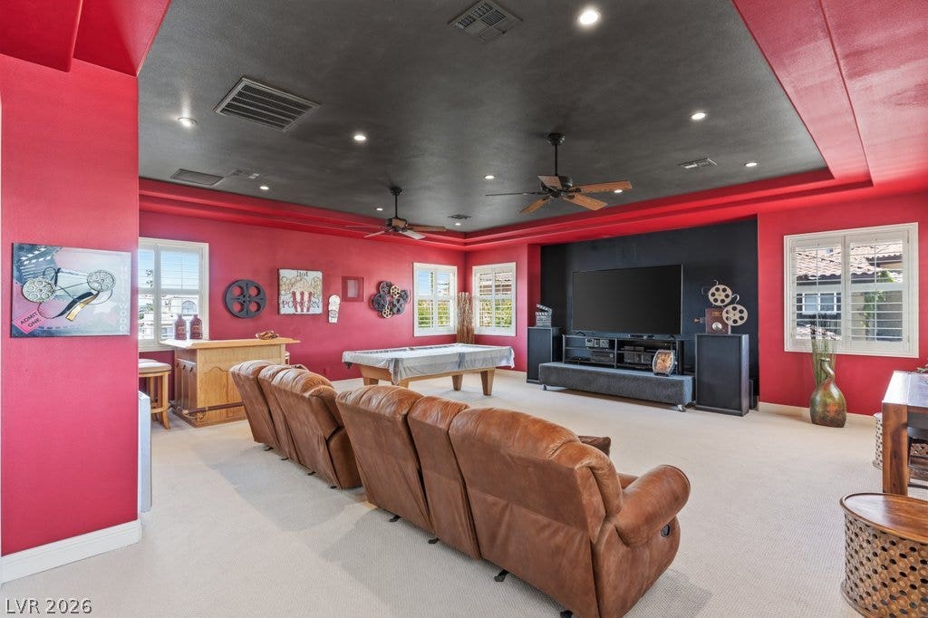 1632 Marbella Ridge Court, Las Vegas, NV 89117 Recessed lighting accents a dark tray ceiling in this spacious media room.