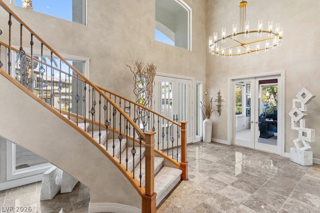 1632 Marbella Ridge Court, Las Vegas, NV 89117 A grand two-story entryway greets visitors with polished tile floors and a curving staircase.