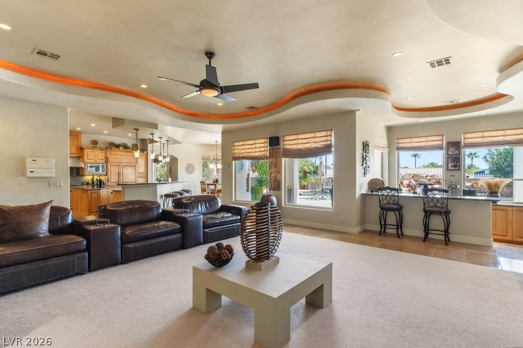 1632 Marbella Ridge Court, Las Vegas, NV 89117 A unique undulating ceiling crowns this open interior with integrated bar and kitchen access.
