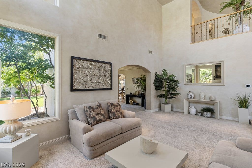 1632 Marbella Ridge Court, Las Vegas, NV 89117 Towering ceilings and grand arched openings frame views of the landscaped yard.