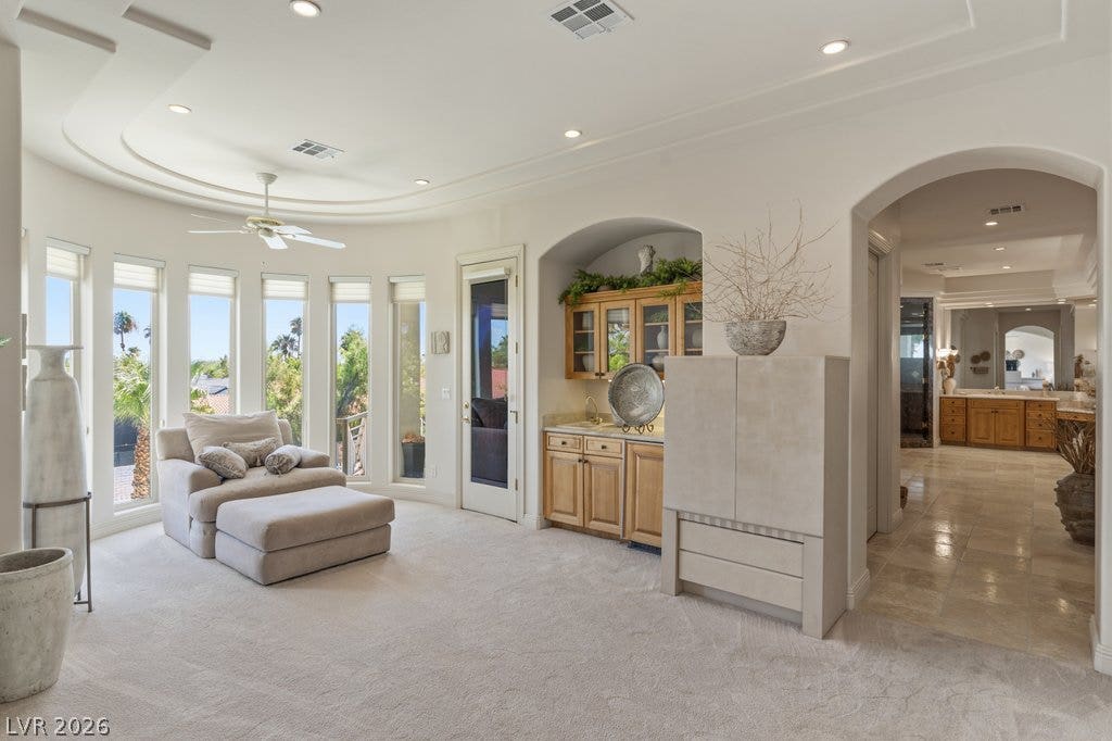 1632 Marbella Ridge Court, Las Vegas, NV 89117 Arched entries and custom ceiling details frame this elegant space leading to a wet bar.
