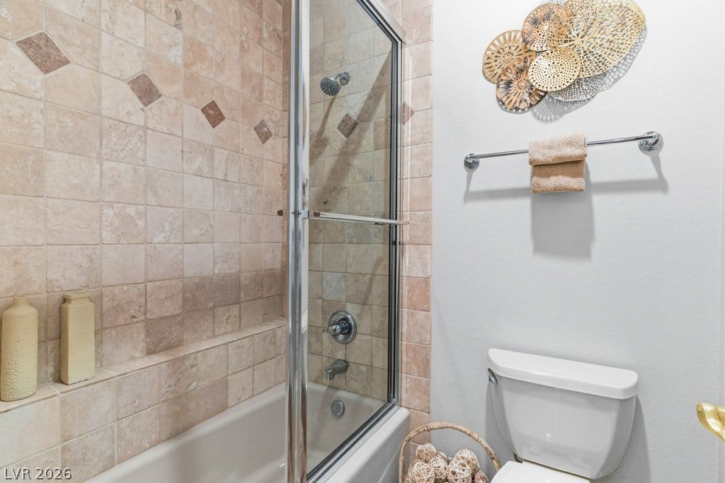 1632 Marbella Ridge Court, Las Vegas, NV 89117 Tiled shower walls surround the built-in bathtub paired with a glass enclosure.