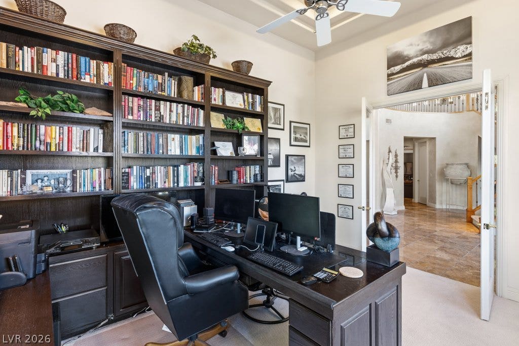 1632 Marbella Ridge Court, Las Vegas, NV 89117 Custom built-in bookcases and elegant French doors define this quiet workspace near the entry.
