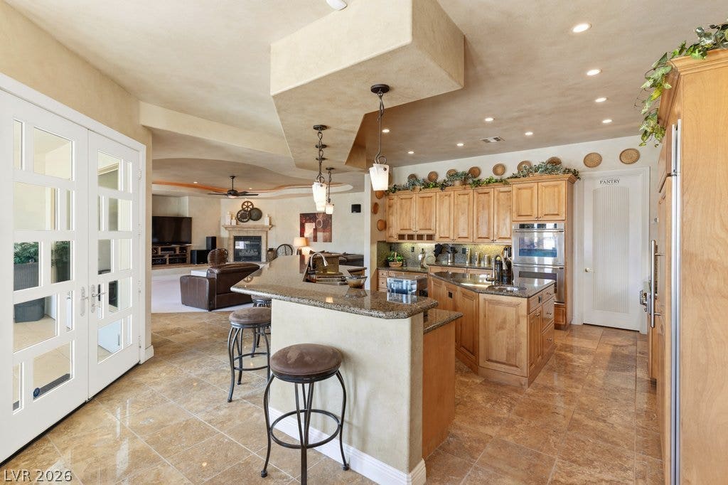 1632 Marbella Ridge Court, Las Vegas, NV 89117 Gleaming tile floors and rich wood cabinetry define this open kitchen design.