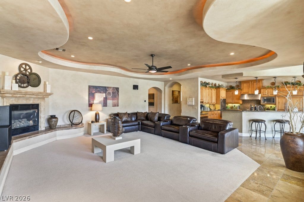1632 Marbella Ridge Court, Las Vegas, NV 89117 Unique sculpted ceilings and a fireplace anchor the open-concept living area and kitchen.