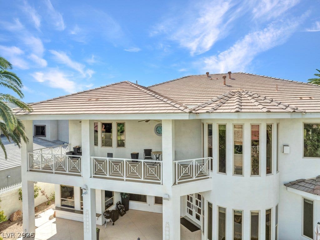 1632 Marbella Ridge Court, Las Vegas, NV 89117 An upper balcony and covered patio detail the rear exterior of this multi-level home.