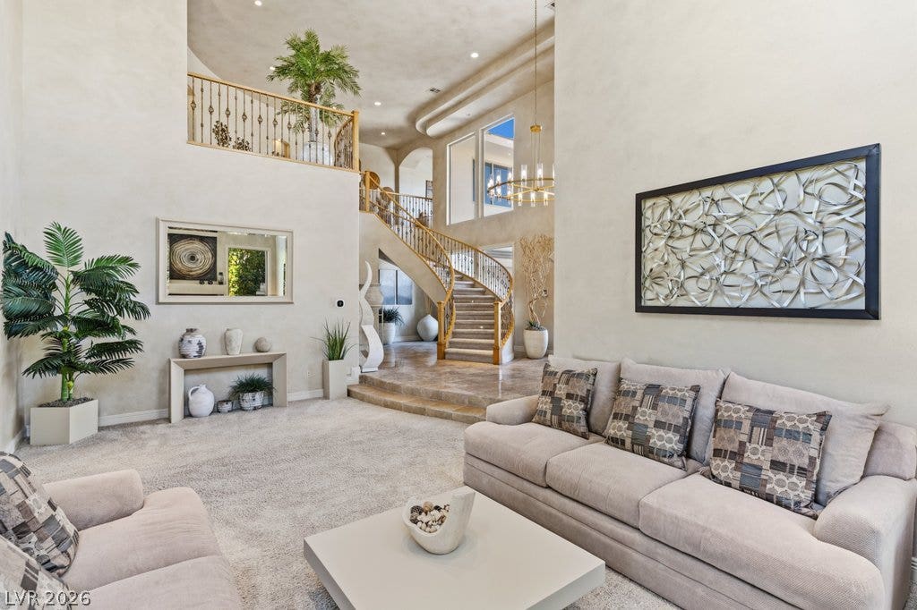 1632 Marbella Ridge Court, Las Vegas, NV 89117 Towering ceilings and a grand curved staircase define this majestic living space.
