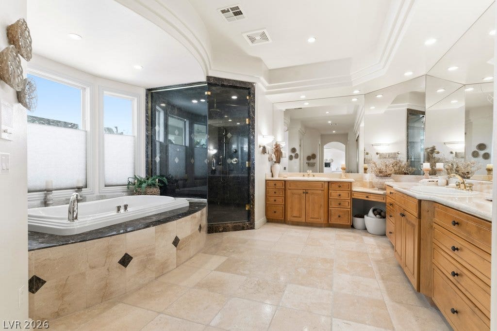 1632 Marbella Ridge Court, Las Vegas, NV 89117 A spacious layout highlights the tile flooring, soaking tub, and custom vanities.