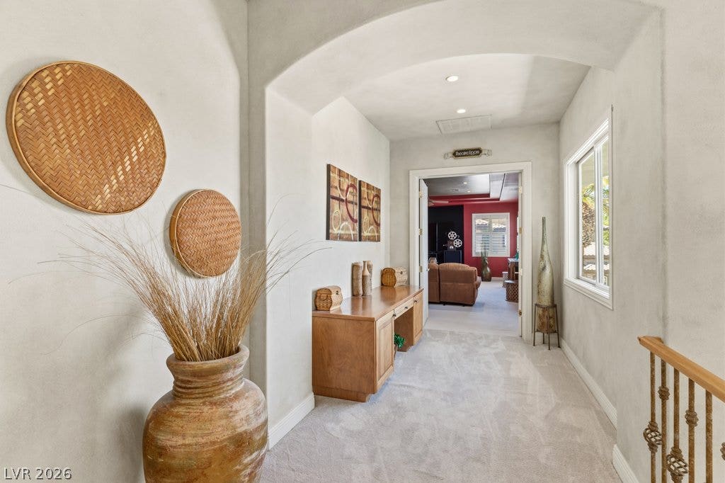 1632 Marbella Ridge Court, Las Vegas, NV 89117 An arched ceiling detail leads into a bright hallway finished with plush carpeting.