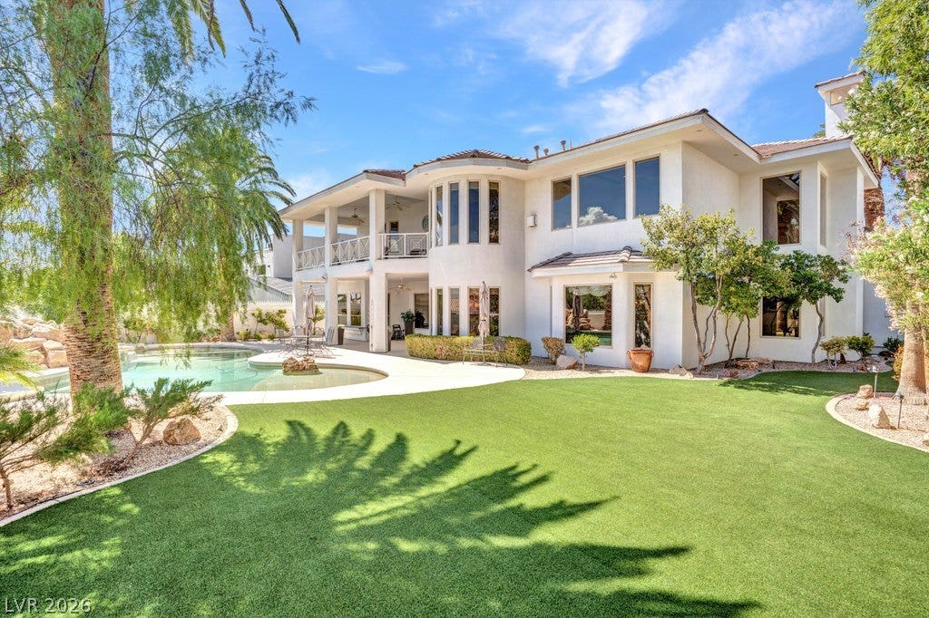 1632 Marbella Ridge Court, Las Vegas, NV 89117 A pristine lawn borders the refreshing swimming pool alongside this magnificent two-story estate.