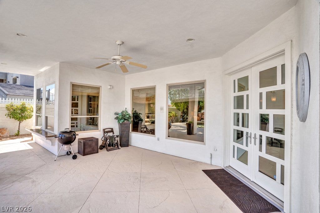 1632 Marbella Ridge Court, Las Vegas, NV 89117 An inviting covered patio features stamped concrete flooring and elegant French doors.