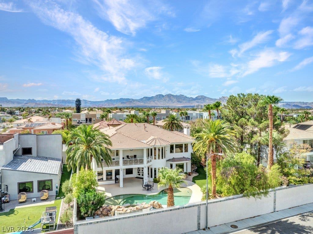 1632 Marbella Ridge Court, Las Vegas, NV 89117 An aerial perspective showcases a tile-roofed residence complete with a private backyard pool.
