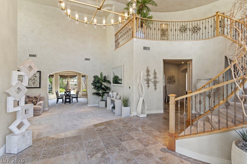 1632 Marbella Ridge Court, Las Vegas, NV 89117 A grand two-story entryway features elegant tile flooring and a sweeping staircase.