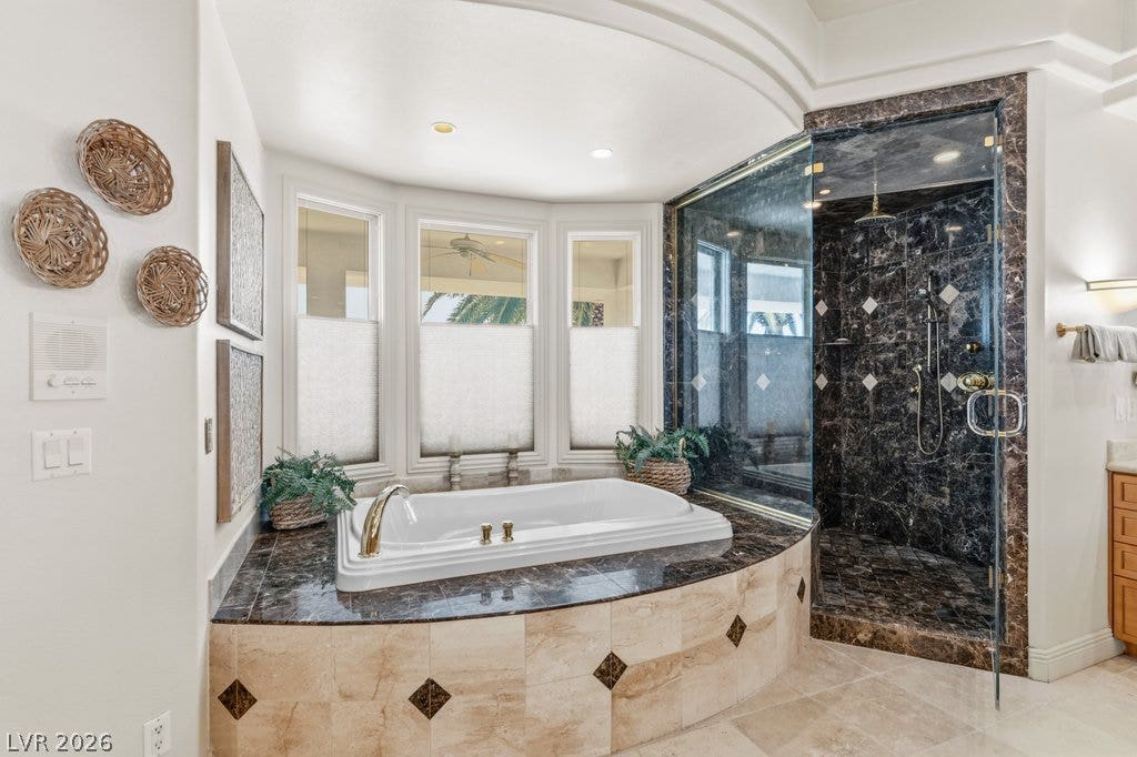 1632 Marbella Ridge Court, Las Vegas, NV 89117 Indulge in the spa-like atmosphere created by a sunken soaking tub and stone-lined walk-in shower.