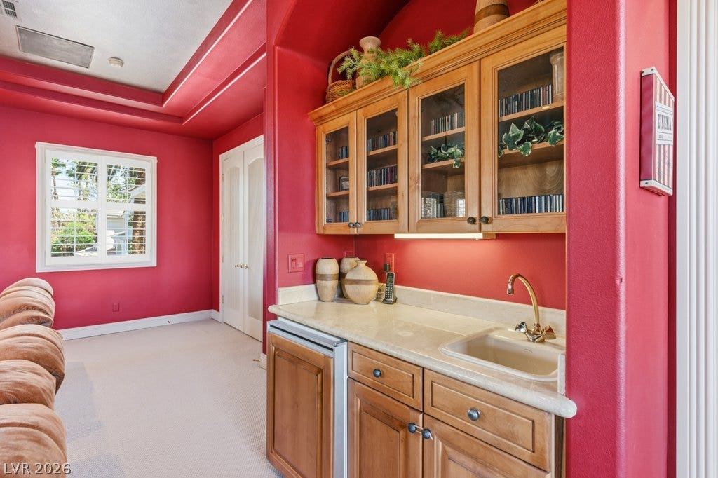 1632 Marbella Ridge Court, Las Vegas, NV 89117 Custom cabinetry and a convenient wet bar elevate this versatile living space.