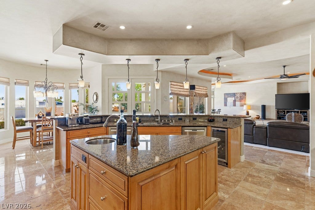 1632 Marbella Ridge Court, Las Vegas, NV 89117 Polished stone flooring and matching granite countertops define this modern, open-concept culinary space.