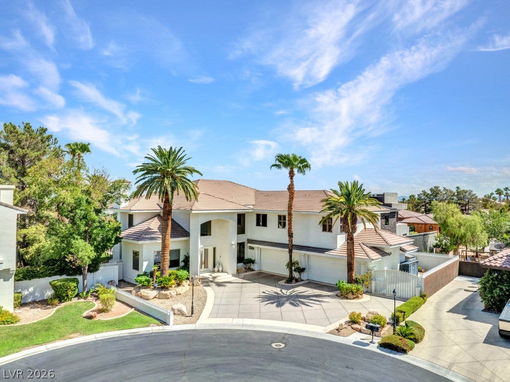 1632 Marbella Ridge Court, Las Vegas, NV 89117 Stately stucco architecture rises behind a gated entry and a paved cul-de-sac motor court.