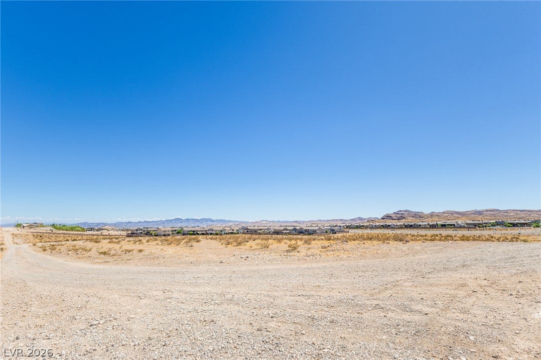 0 SE Corner of Hualapai & Pebble, Las Vegas, NV 89178 Expansive desert vistas stretch toward distant mountains under a clear blue sky.