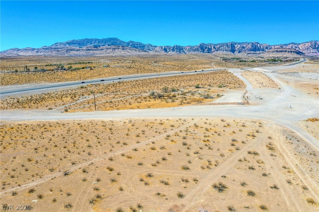 0 SE Corner of Hualapai & Pebble, Las Vegas, NV 89178 Dramatic mountain ranges frame this expansive desert parcel under clear blue skies.