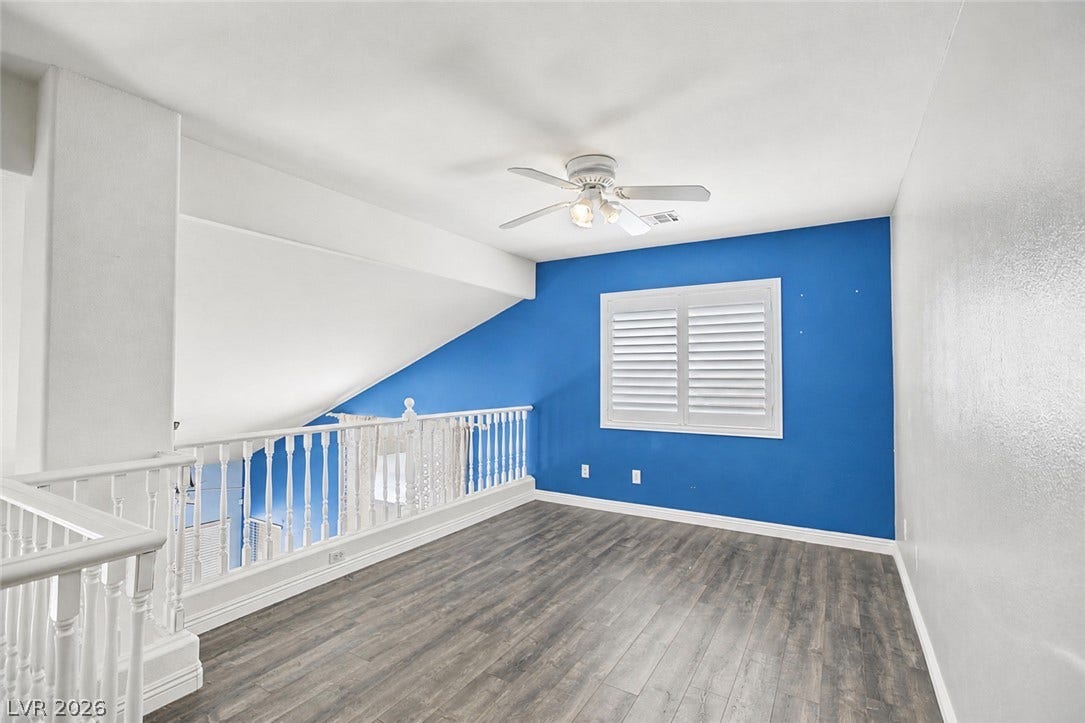 911 Sterling Thorn Court, Las Vegas, NV 89183 Gleaming wood-look floors anchor a versatile upper-level loft space framed by white railings.