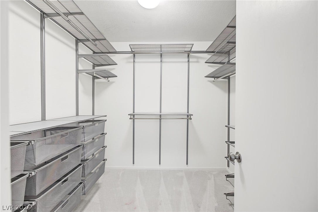 911 Sterling Thorn Court, Las Vegas, NV 89183 Custom closet in primary with wire shelving and pull-out drawers.