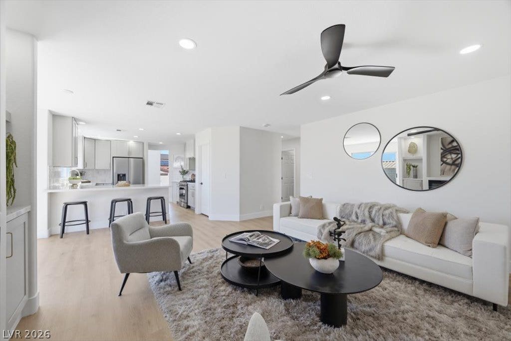 139 Skytop Drive, Henderson, NV 89015 An open floor plan flows seamlessly connects a modern kitchen to a comfortable living area, perfect for entertaining.