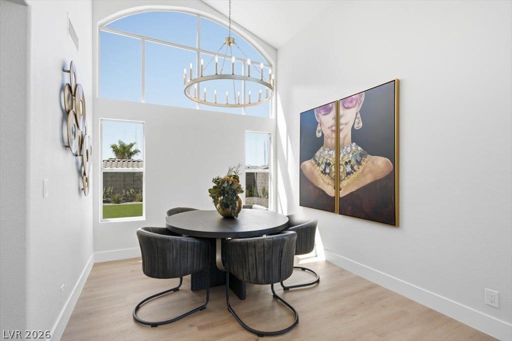 139 Skytop Drive, Henderson, NV 89015 Soaring vaulted ceilings and a large arched window illuminate this elegant dining area.