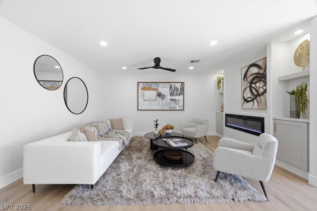 139 Skytop Drive, Henderson, NV 89015 A bright, inviting family room featuring custom built-ins and a sleek contemporary fireplace.