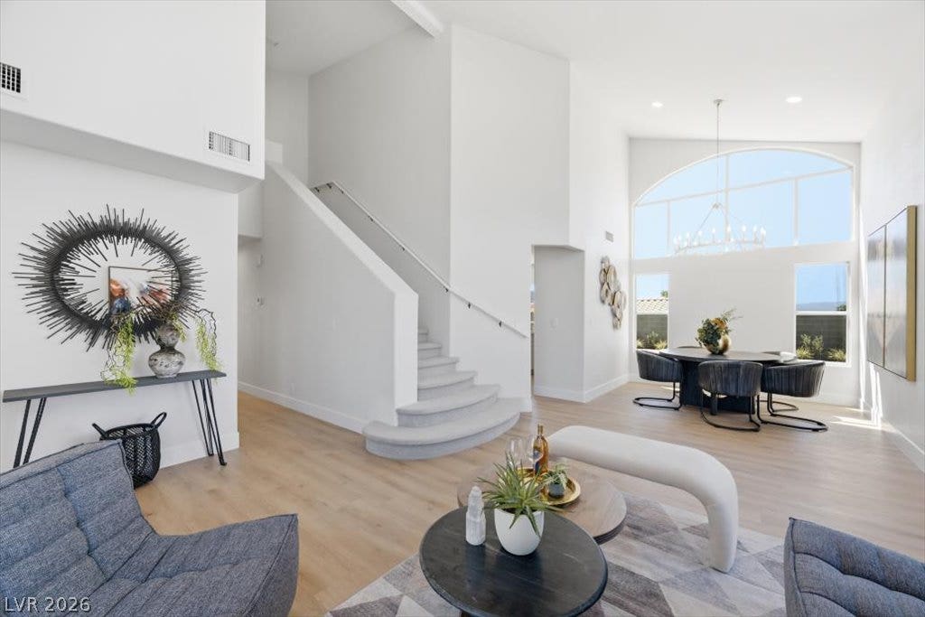 139 Skytop Drive, Henderson, NV 89015 Soaring ceilings and warm wood floors anchor this architectural entryway and formal dining space.