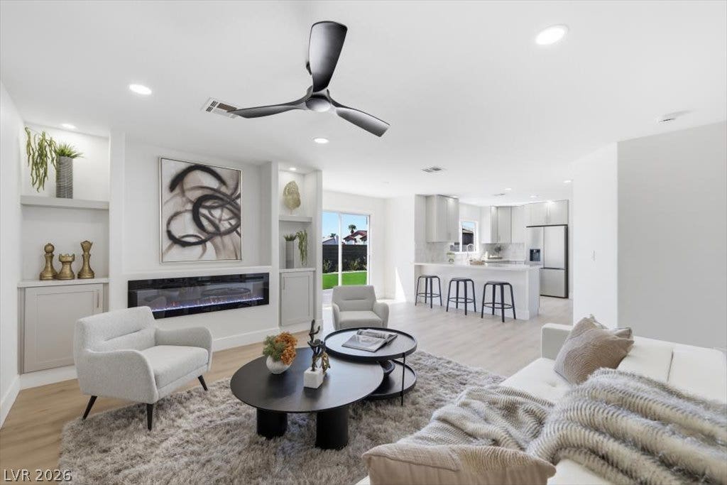 139 Skytop Drive, Henderson, NV 89015 An open floor plan flows seamlessly connects a modern kitchen to a comfortable living area, perfect for entertaining.