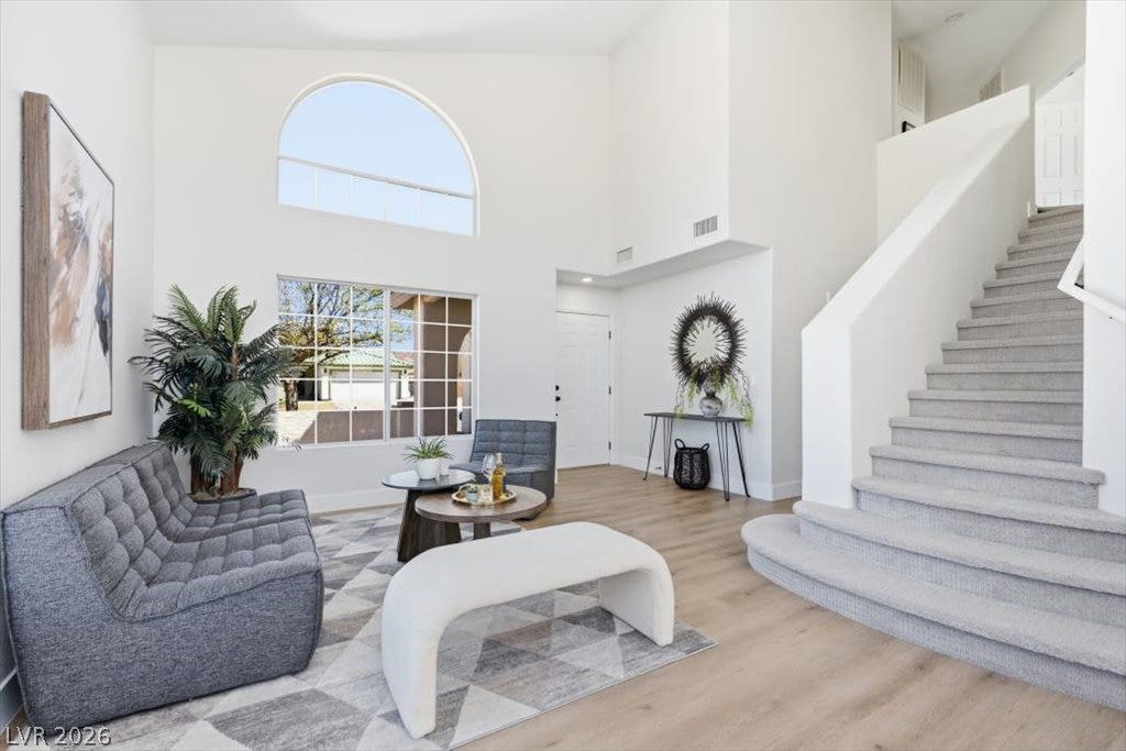139 Skytop Drive, Henderson, NV 89015 A spacious double-height foyer showcases an abudance of natural light and luxury vinyl floorng.