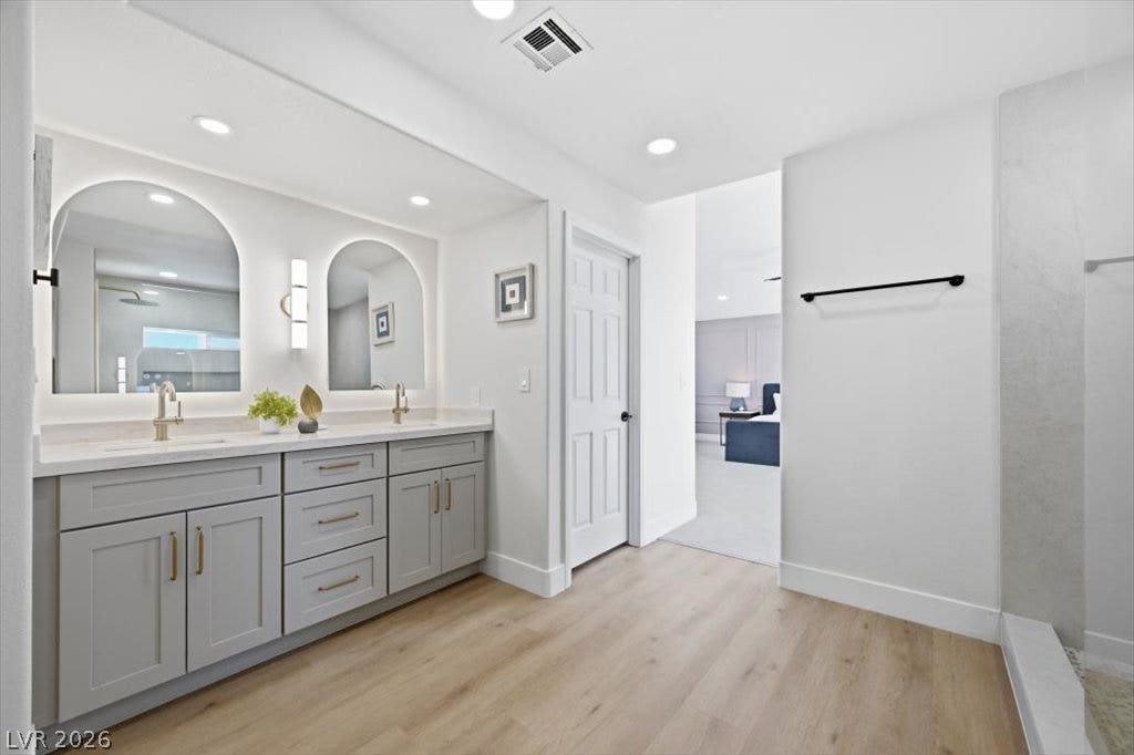 139 Skytop Drive, Henderson, NV 89015 Dual vanities with modern finishes elevate this spacious primary bathroom.