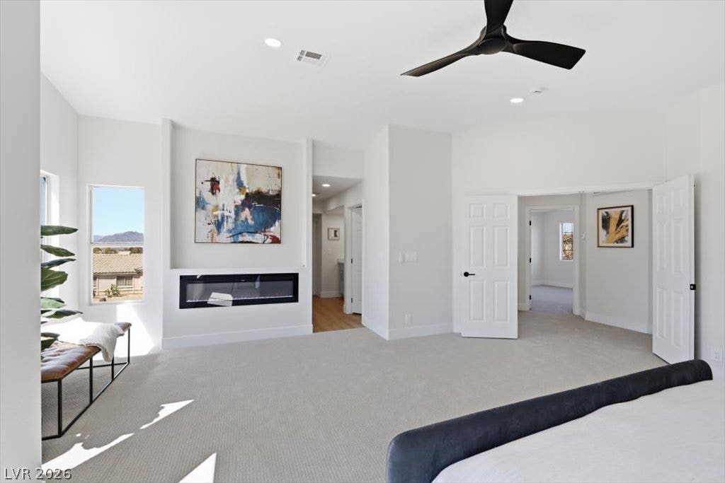 139 Skytop Drive, Henderson, NV 89015 An integrated fireplace accents this bedroom layout complete with premium tailored carpeting and natural light.