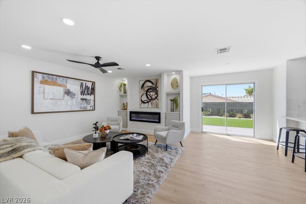 139 Skytop Drive, Henderson, NV 89015 A bright, inviting family room featuring custom built-ins and a sleek contemporary fireplace.