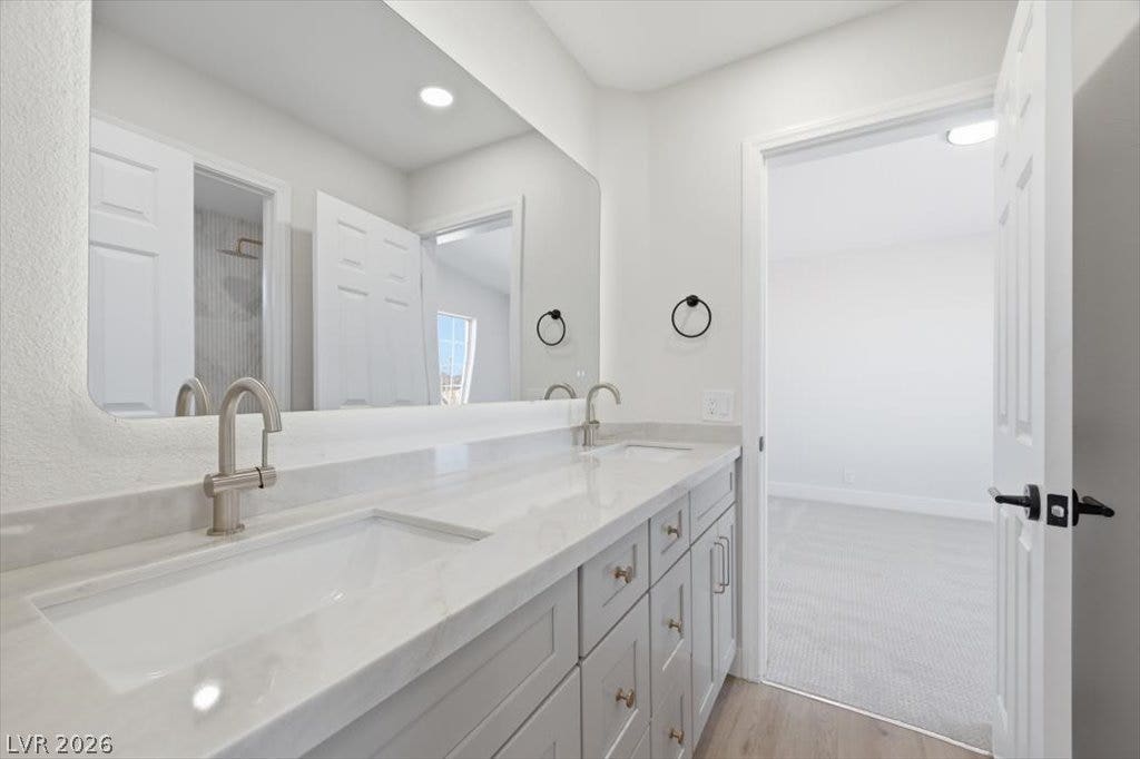 139 Skytop Drive, Henderson, NV 89015 Double vanities with squartz countertops define this elegant bathroom space.