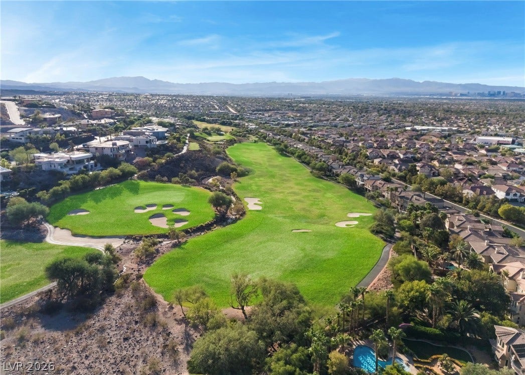 1343 Quiet River Avenue, Henderson, NV 89012 Lush fairways wind through a vibrant community framed by majestic distant mountain peaks.