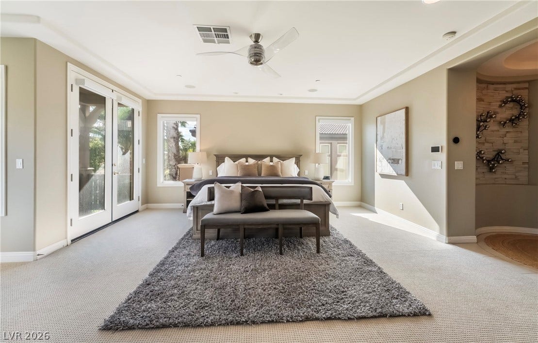 1343 Quiet River Avenue, Henderson, NV 89012 Double doors open to the outdoors in this bedroom featuring recessed lighting and carpet floors.